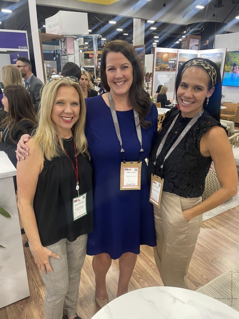 Jana smiling with friends at IMEX