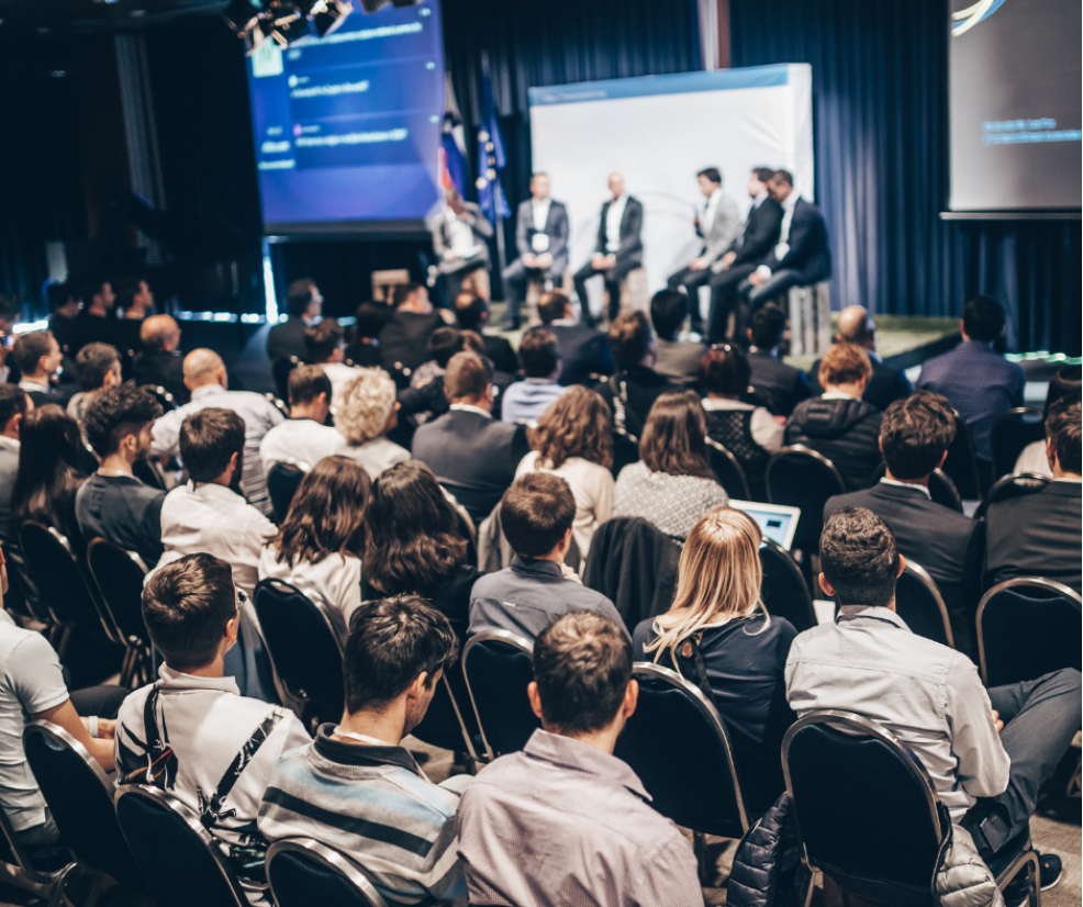 An audience listening to a group panel discussion.